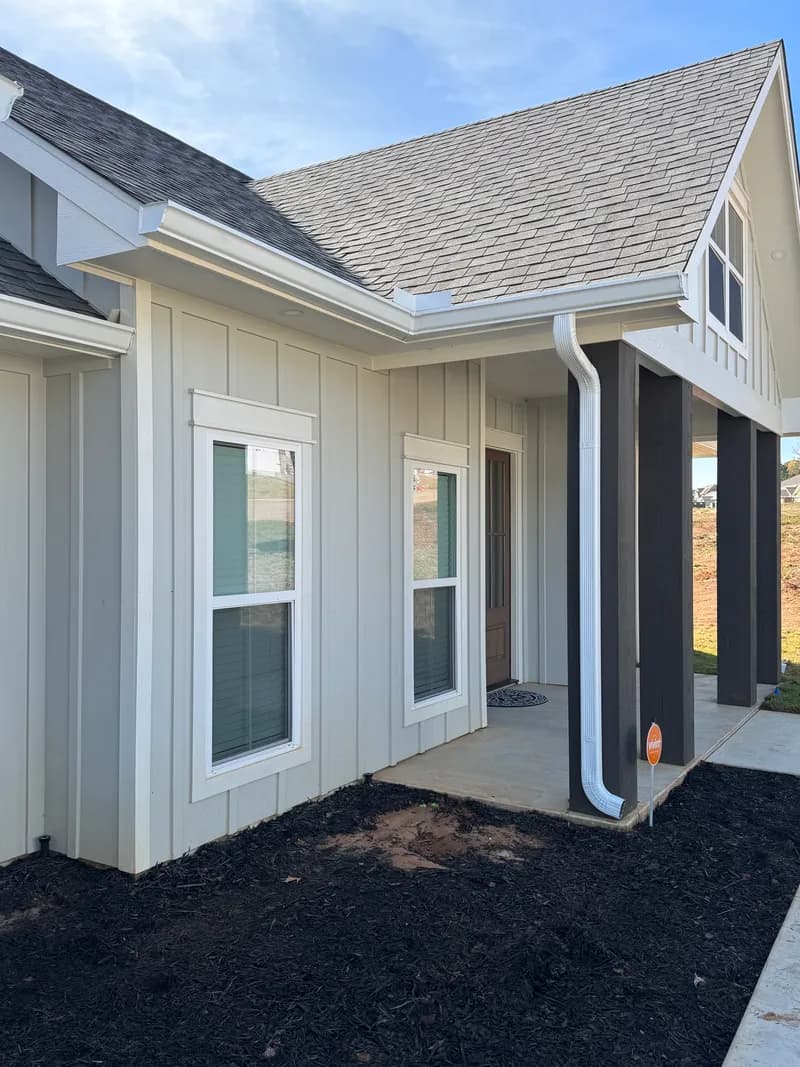 Downspout installation detail on a Texas property